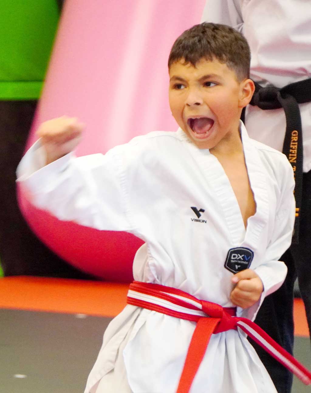 a kid is showing confidence in the martial arts class